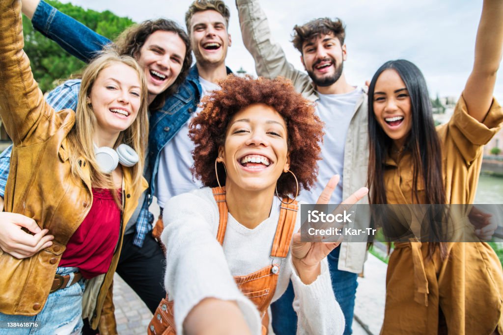 Group of happy friends taking selfie pic outside.